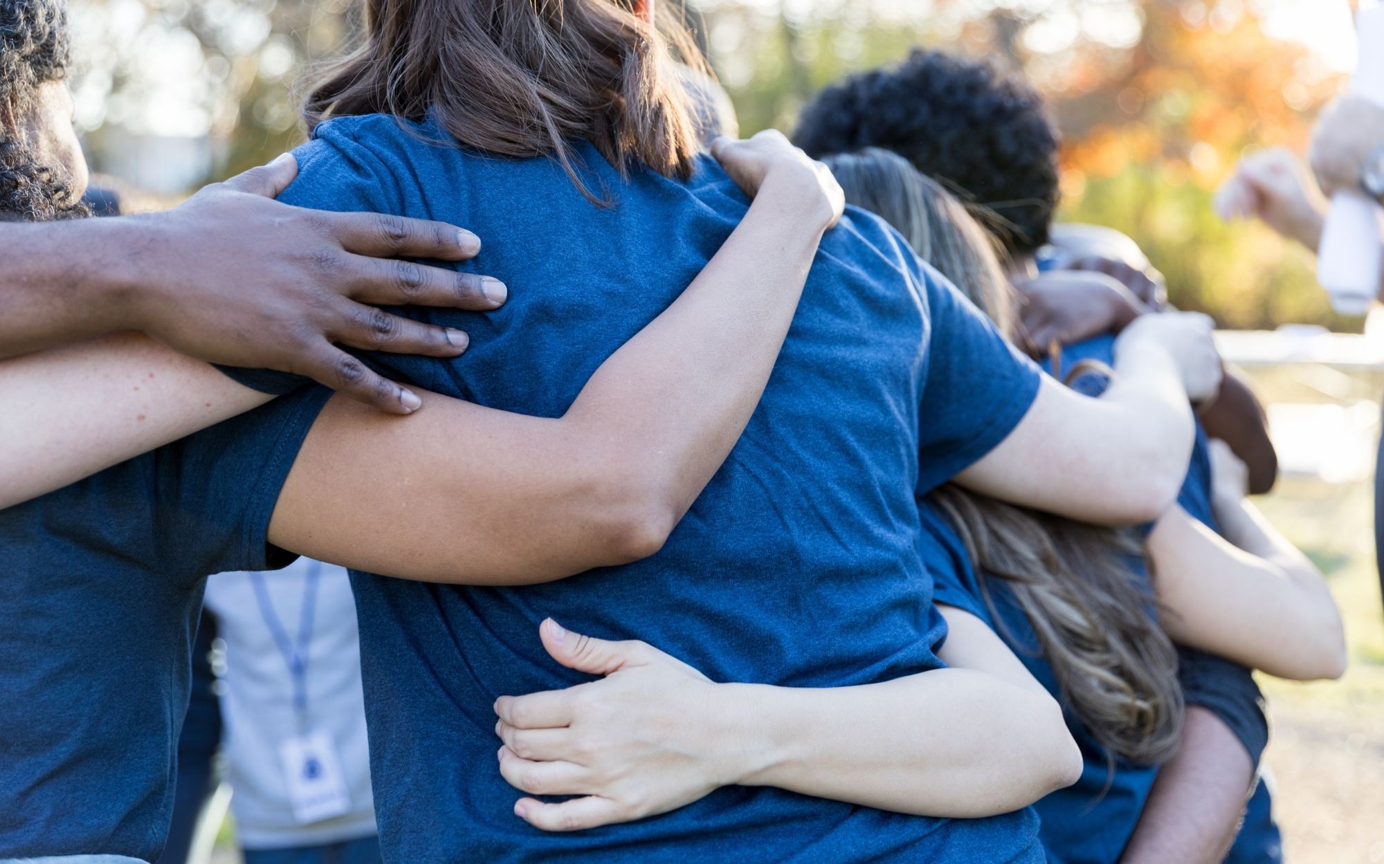 Community hugging and supporting each other